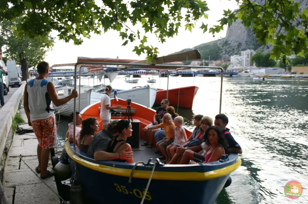 Wooden excursion boat full of passengers on the Cetina river in Omiš ready to depart